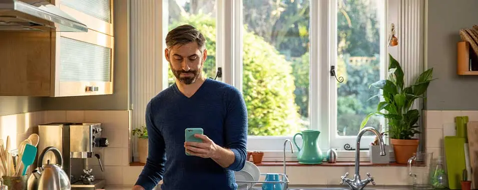Man on phone in kitchen